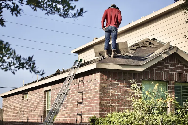 Professional roofer working on a residential roof in Cal-Vel